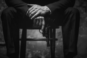 A man holding a gun planning conspiracy defense in West Palm Beach