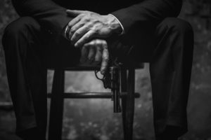 A man holding a gun planning conspiracy defense in West Palm Beach