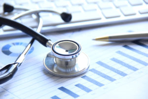 Stethoscope resting over medical documents. This picture symbolizes healthcare fraud in West Palm Beach.
