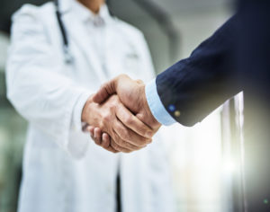 A handshake between a doctor and a patient. Patient Brokering in West Palm Beach.