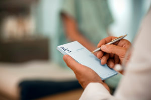 Doctor writing an illegal prescription in West Palm Beach. his is also known as prescription fraud.